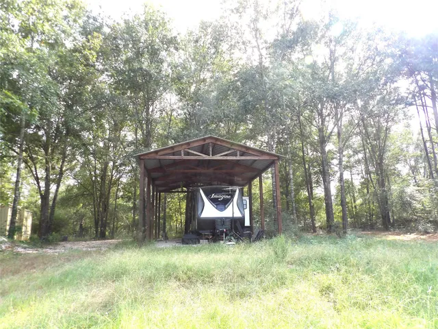 a backyard of a house with barbeque oven