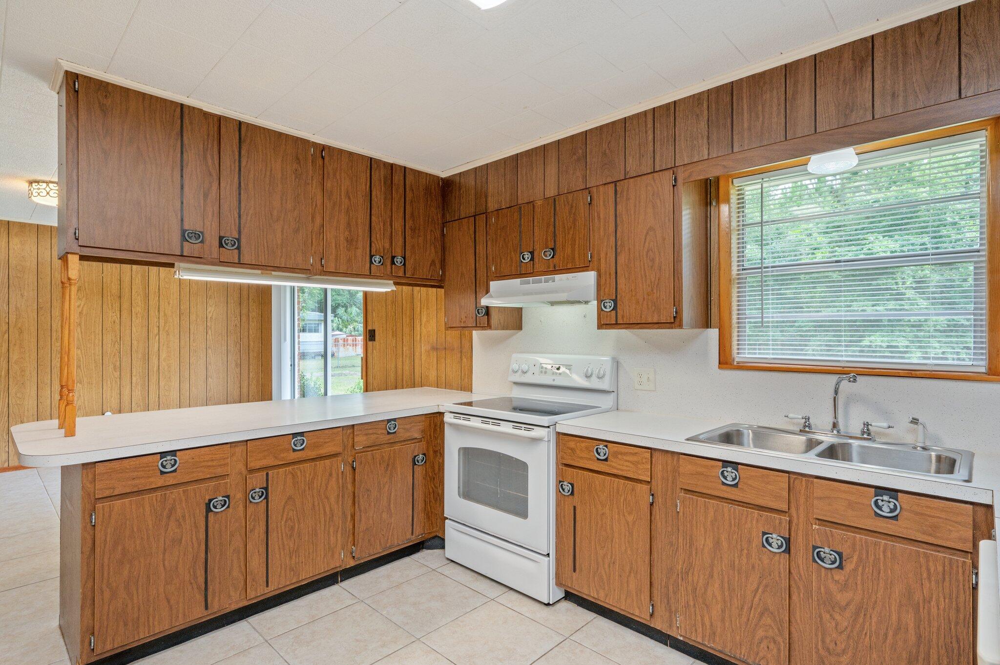 367 Andy Nowling Road DeFuniak Springs, FL 32433 - Photo 12 of 36 a kitchen with cabinets appliances a sink and a window