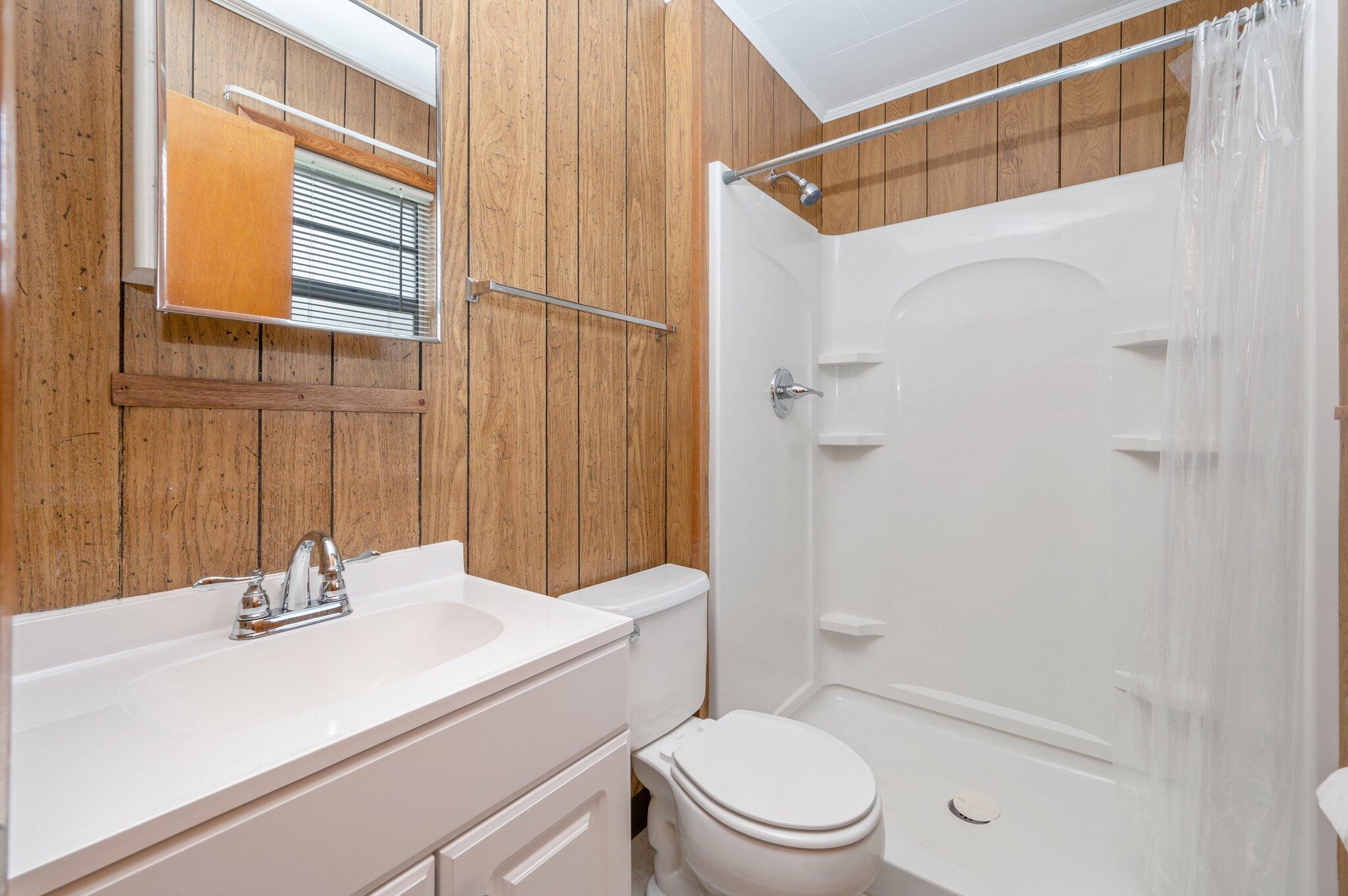 367 Andy Nowling Road DeFuniak Springs, FL 32433 - Photo 19 of 36 a bathroom with a sink toilet and shower