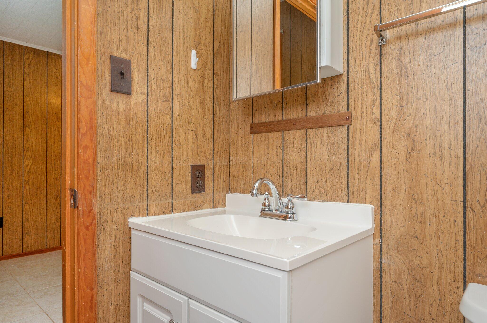 367 Andy Nowling Road DeFuniak Springs, FL 32433 - Photo 21 of 36 a bathroom with a sink and a mirror