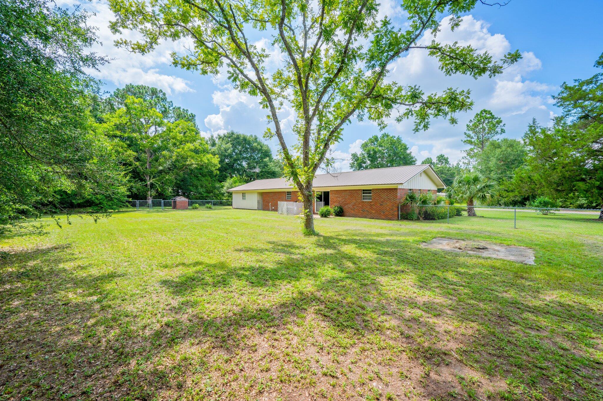 367 Andy Nowling Road DeFuniak Springs, FL 32433 - Photo 31 of 36 a view of a house with a yard