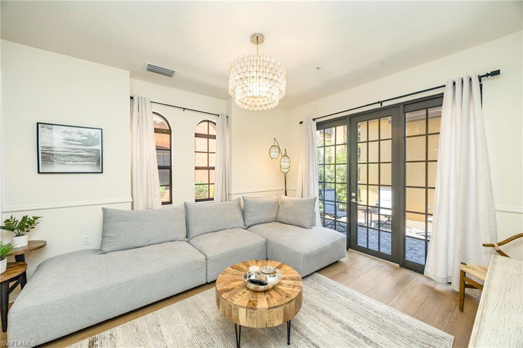 9128 Delano Street, Unit 892 Naples, FL 34113 - Photo 13 of 49 a living room with furniture and a large window