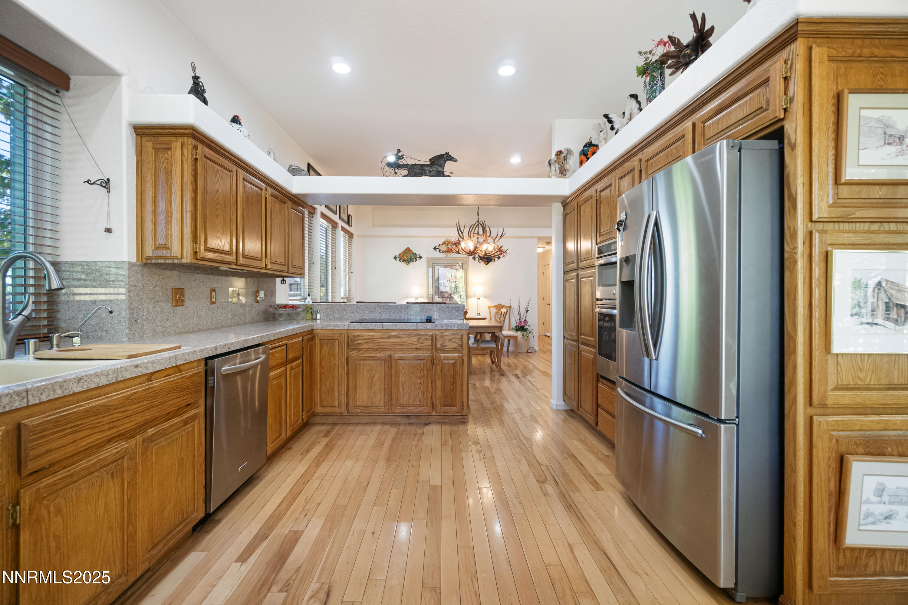 1216 Pleasantview Drive Gardnerville, NV 89460 - Photo 11 of 32 a large kitchen with stainless steel appliances granite countertop a refrigerator and a sink