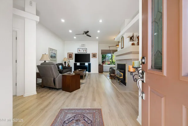 a living room with furniture a fireplace and a flat screen tv