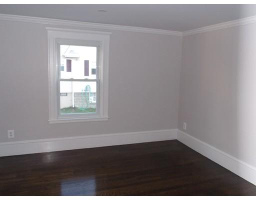 10 Fulton Street Woburn, MA 01801 - Photo 18 of 34 an empty room with wooden floor and windows