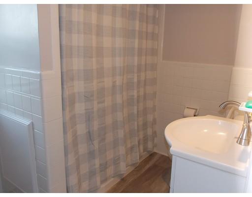 10 Fulton Street Woburn, MA 01801 - Photo 24 of 34 a bathroom with a sink a toilet and shower curtain