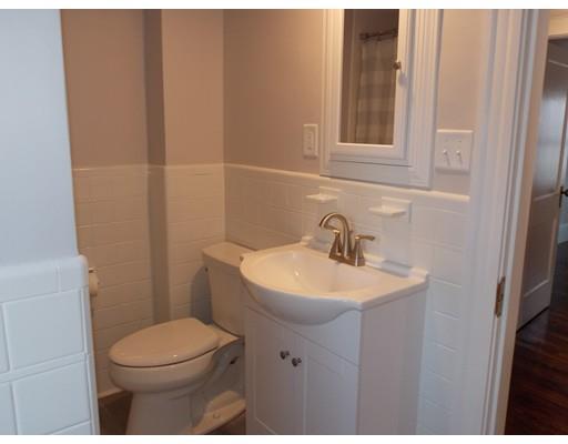 10 Fulton Street Woburn, MA 01801 - Photo 25 of 34 a bathroom with a sink a toilet and mirror