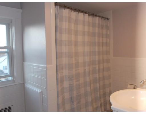 10 Fulton Street Woburn, MA 01801 - Photo 26 of 34 a bathroom with a shower curtain and a sink