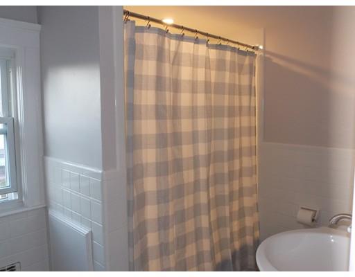 10 Fulton Street Woburn, MA 01801 - Photo 27 of 34 a bathroom with a sink and a shower curtain