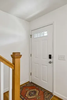 a view of a hallway with wooden floor and cabinet