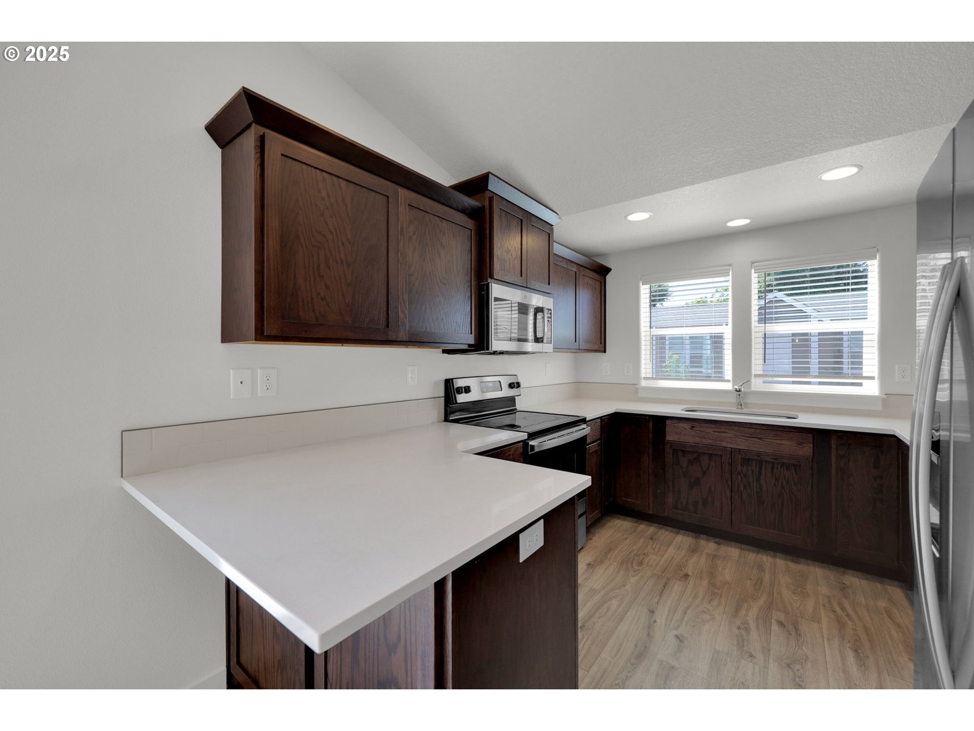 463 35th Street Springfield, OR 97478 - Photo 13 of 41 a kitchen with a sink a stove a microwave and cabinets