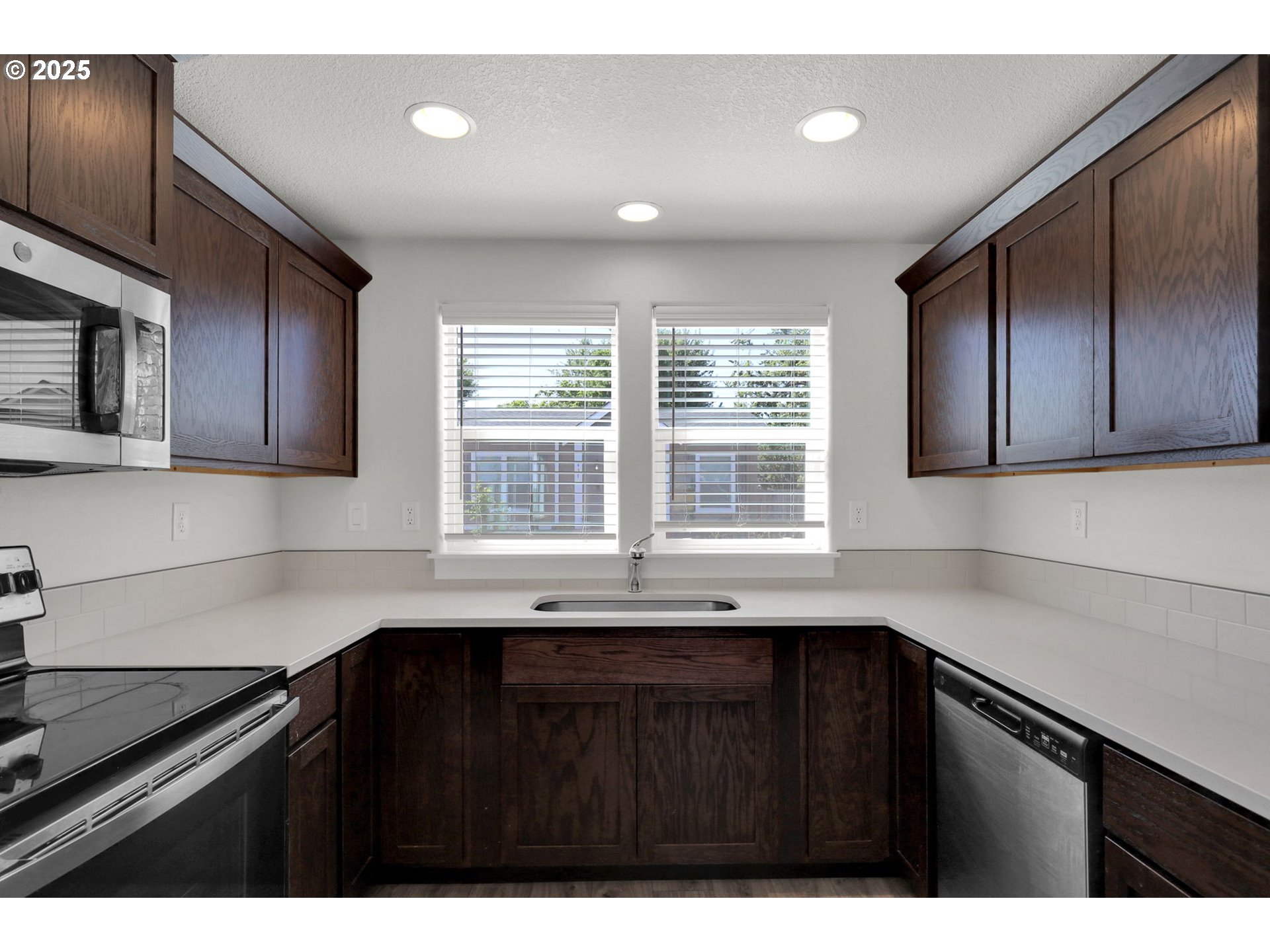 463 35th Street Springfield, OR 97478 - Photo 14 of 41 a kitchen with a sink a microwave and cabinets