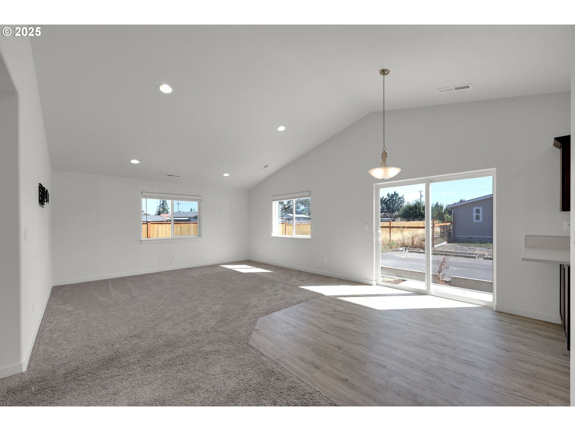 463 35th Street Springfield, OR 97478 - Photo 4 of 41 a view of an empty room with wooden floor and a window
