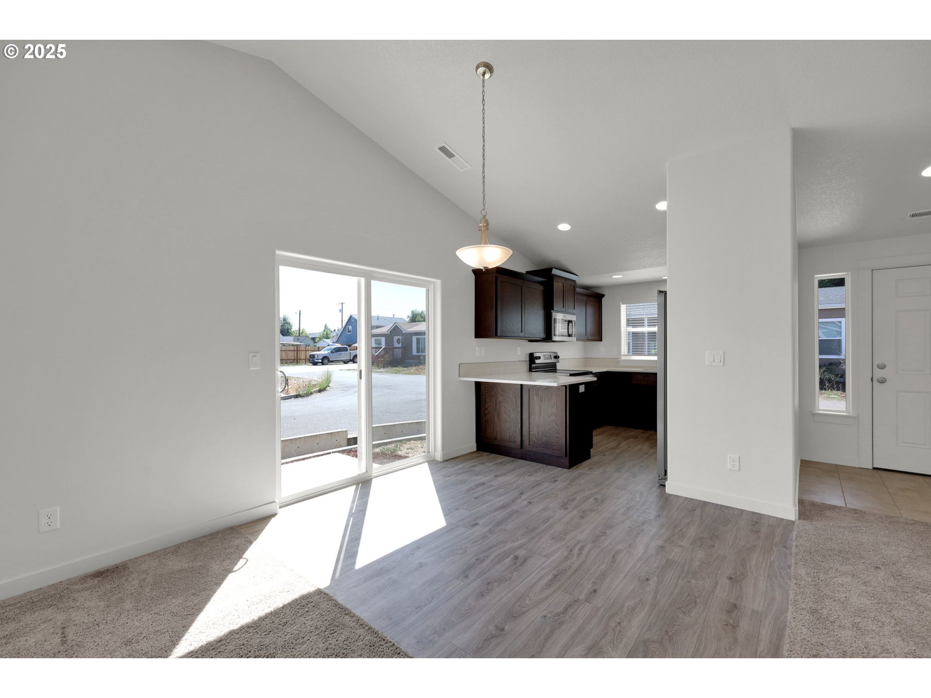 463 35th Street Springfield, OR 97478 - Photo 10 of 41 a open kitchen with a refrigerator a sink dishwasher with a dining table and chairs