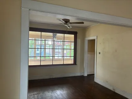 a view of room with a ceiling fan and window