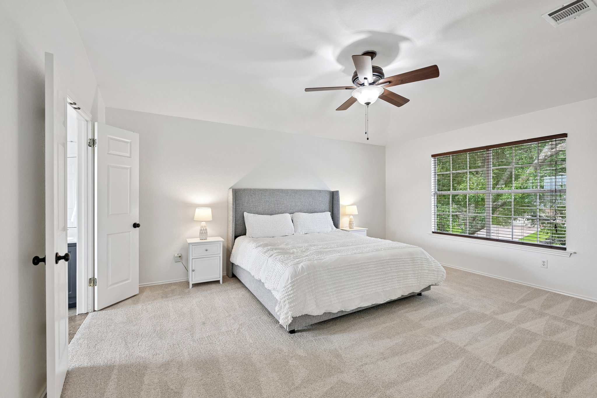 4100 Mocha Trail Austin, TX 78728 - Photo 13 of 33 Plush carpeted floors and a warm ceiling fan create a serene and inviting bedroom space.