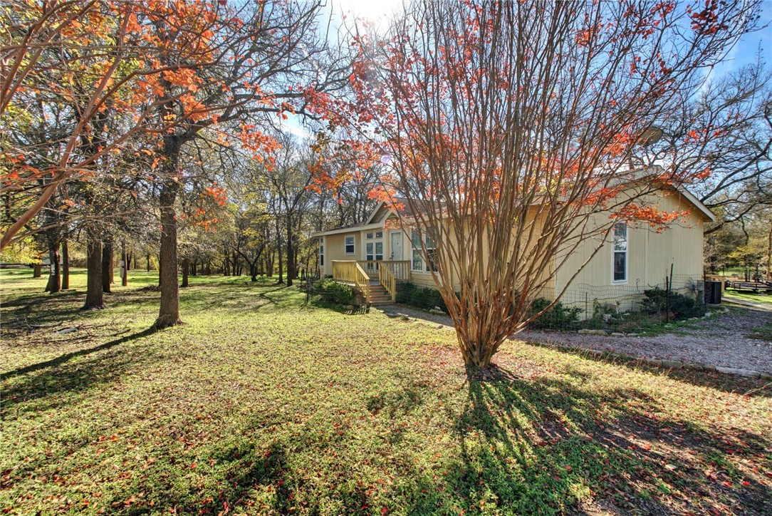 111 Hogeye Road Elgin, TX 78621 - Photo 1 of 1 The well-groomed front yard is perfect for lounging and enjoying some outside time.