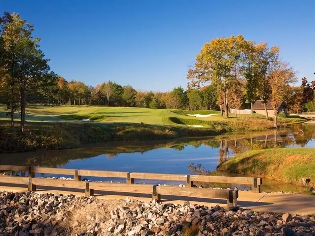an aerial view of residential houses with outdoor space and lake view