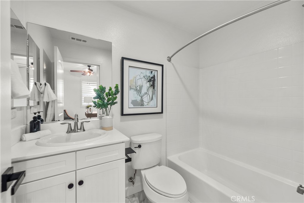 22157 Barrington Way Saugus, CA 91350 - Photo 17 of 46 a bathroom with a bathtub shower sink mirror vanity and toilet