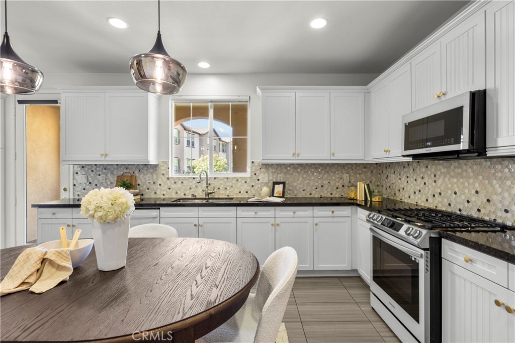 22157 Barrington Way Saugus, CA 91350 - Photo 19 of 46 a kitchen with stainless steel appliances granite countertop a sink and microwave