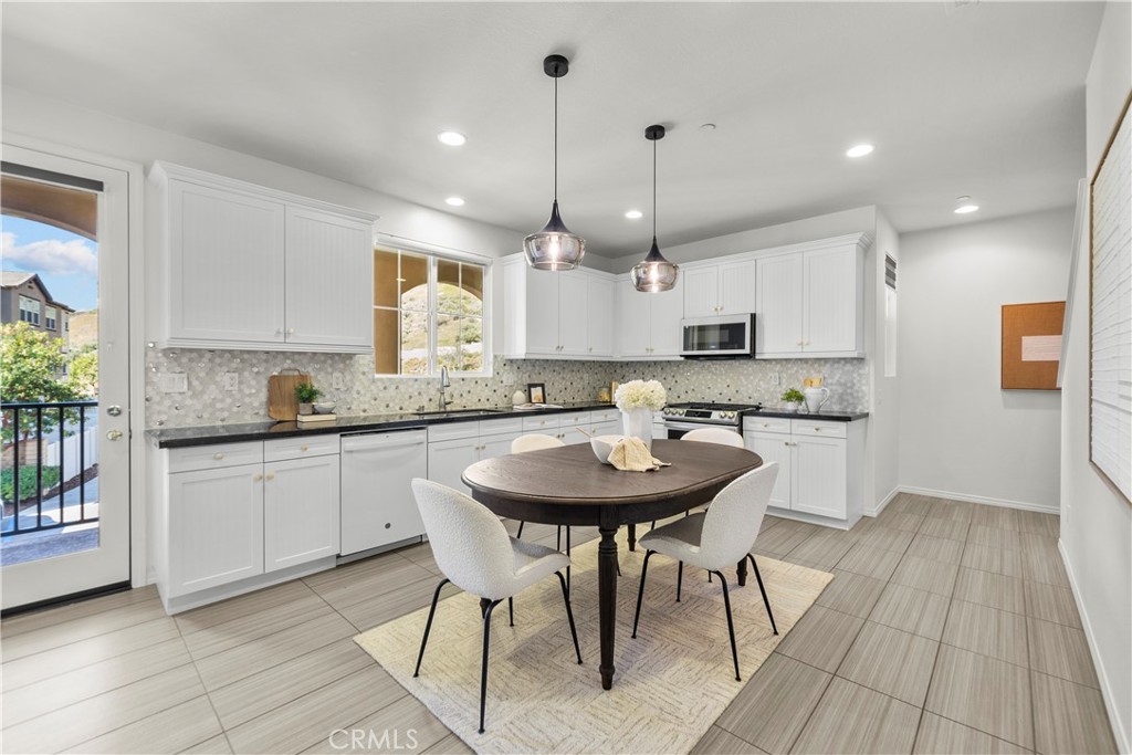 22157 Barrington Way Saugus, CA 91350 - Photo 20 of 46 a kitchen with kitchen island granite countertop a sink a center island and cabinets