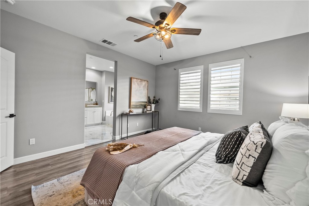 22157 Barrington Way Saugus, CA 91350 - Photo 26 of 46 a bedroom with a large bed and a chandelier