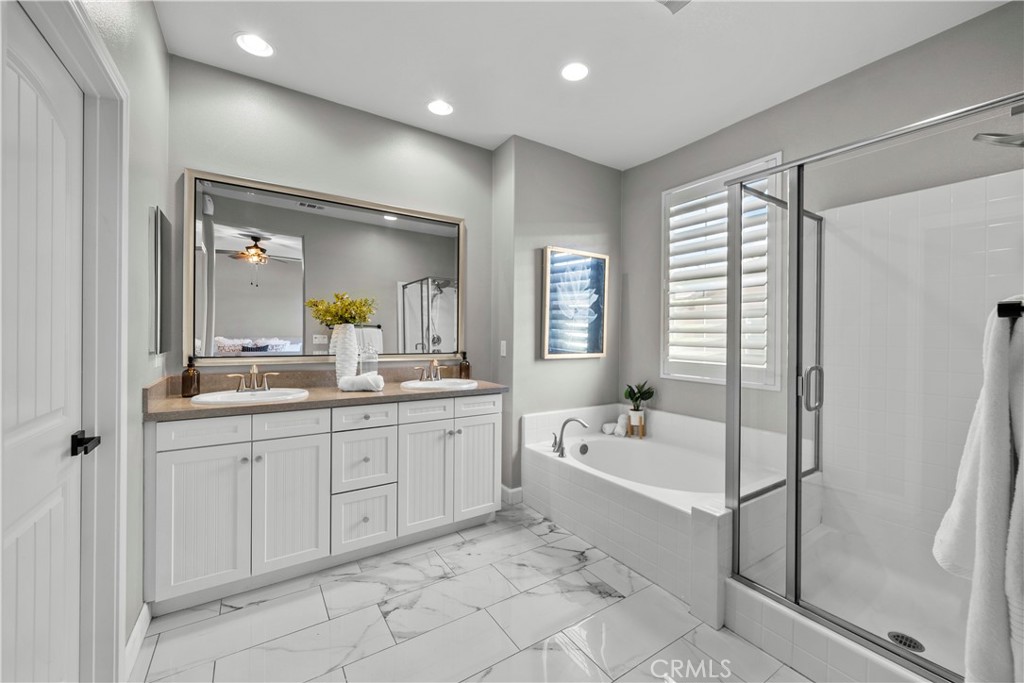 22157 Barrington Way Saugus, CA 91350 - Photo 27 of 46 a bathroom with a tub sink and mirror