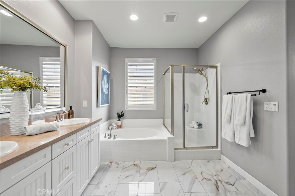 22157 Barrington Way Saugus, CA 91350 - Photo 28 of 46 a spacious bathroom with a double vanity sink a mirror and a bathtub