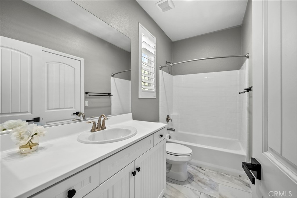 22157 Barrington Way Saugus, CA 91350 - Photo 33 of 46 a bathroom with a sink a toilet and shower