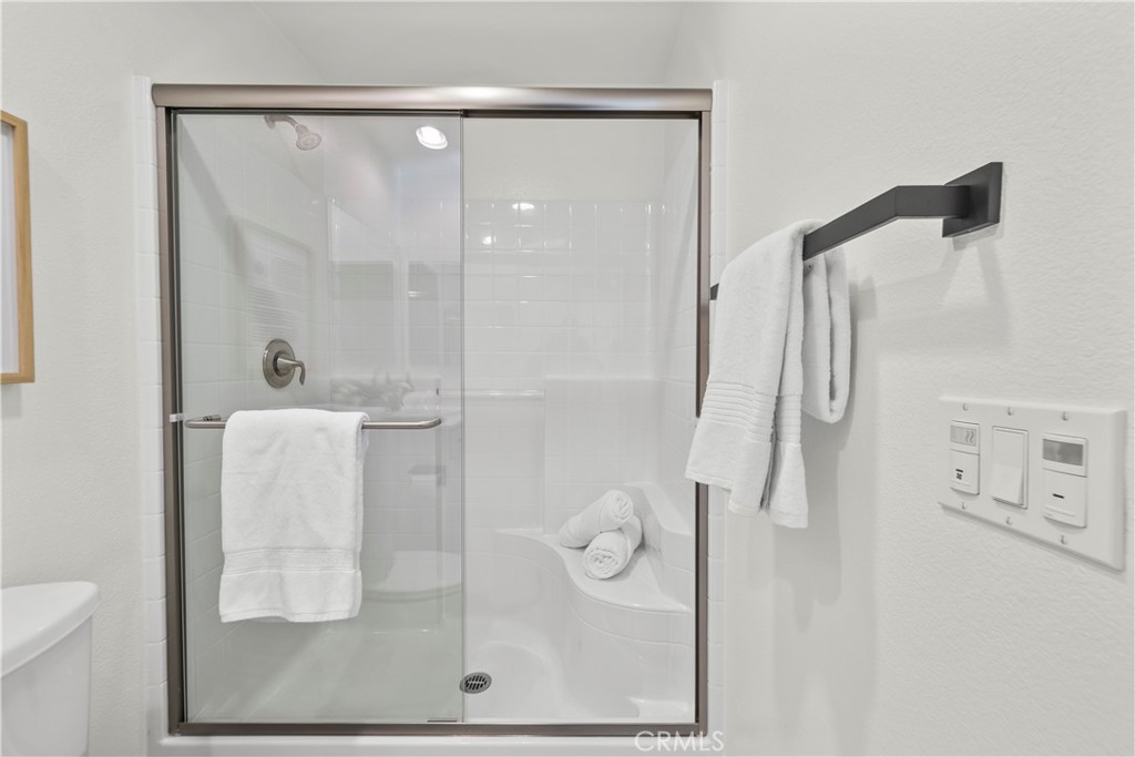 22157 Barrington Way Saugus, CA 91350 - Photo 10 of 46 a bathroom with a glass shower door