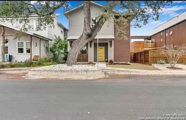 a kitchen with stainless steel appliances kitchen island granite countertop a refrigerator and a sink