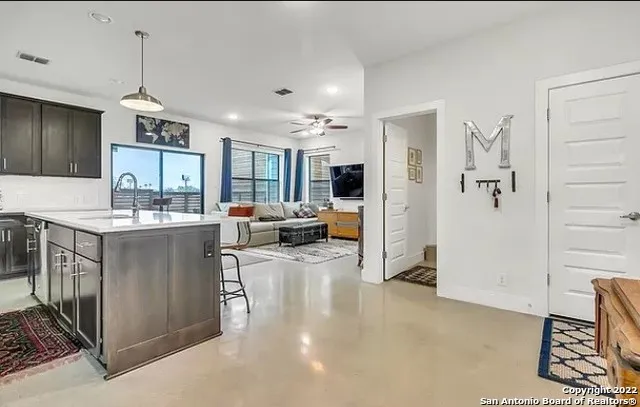 a view of living room with granite countertop furniture and a flat screen tv
