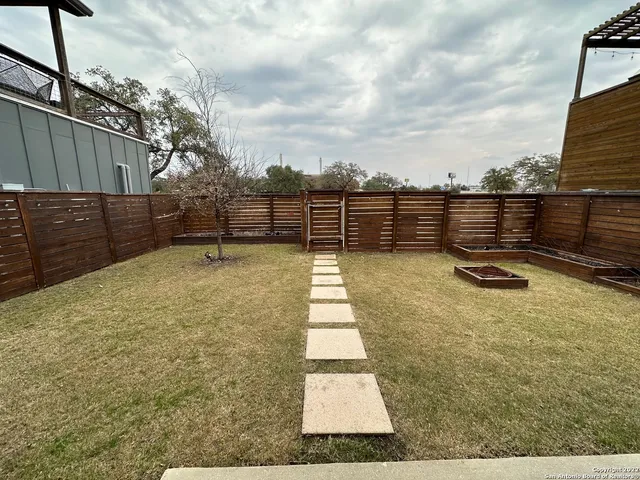 a view of a backyard with table and chairs