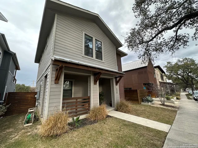 a view of a house with a yard and garage
