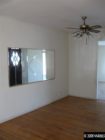 1285 Trainer Way Reno, NV 89512 - Photo 2 of 9 an empty room with wooden floor fan and windows
