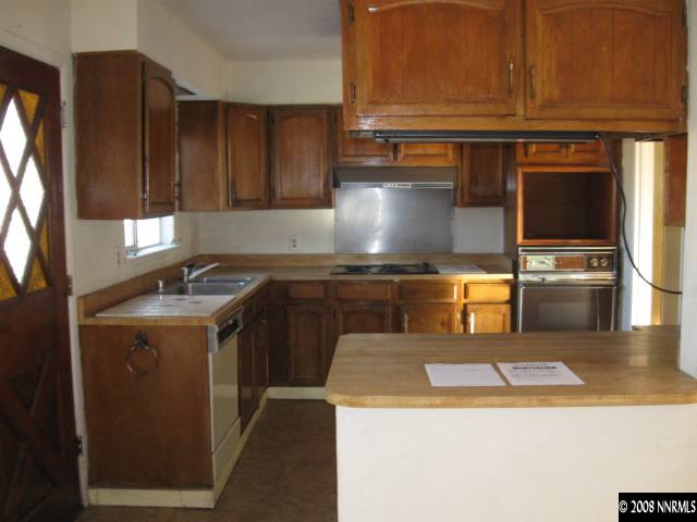 1285 Trainer Way Reno, NV 89512 - Photo 4 of 9 a kitchen with a sink a stove and cabinets