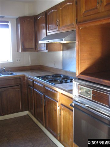 1285 Trainer Way Reno, NV 89512 - Photo 5 of 9 a kitchen with granite countertop stainless steel appliances and cabinets