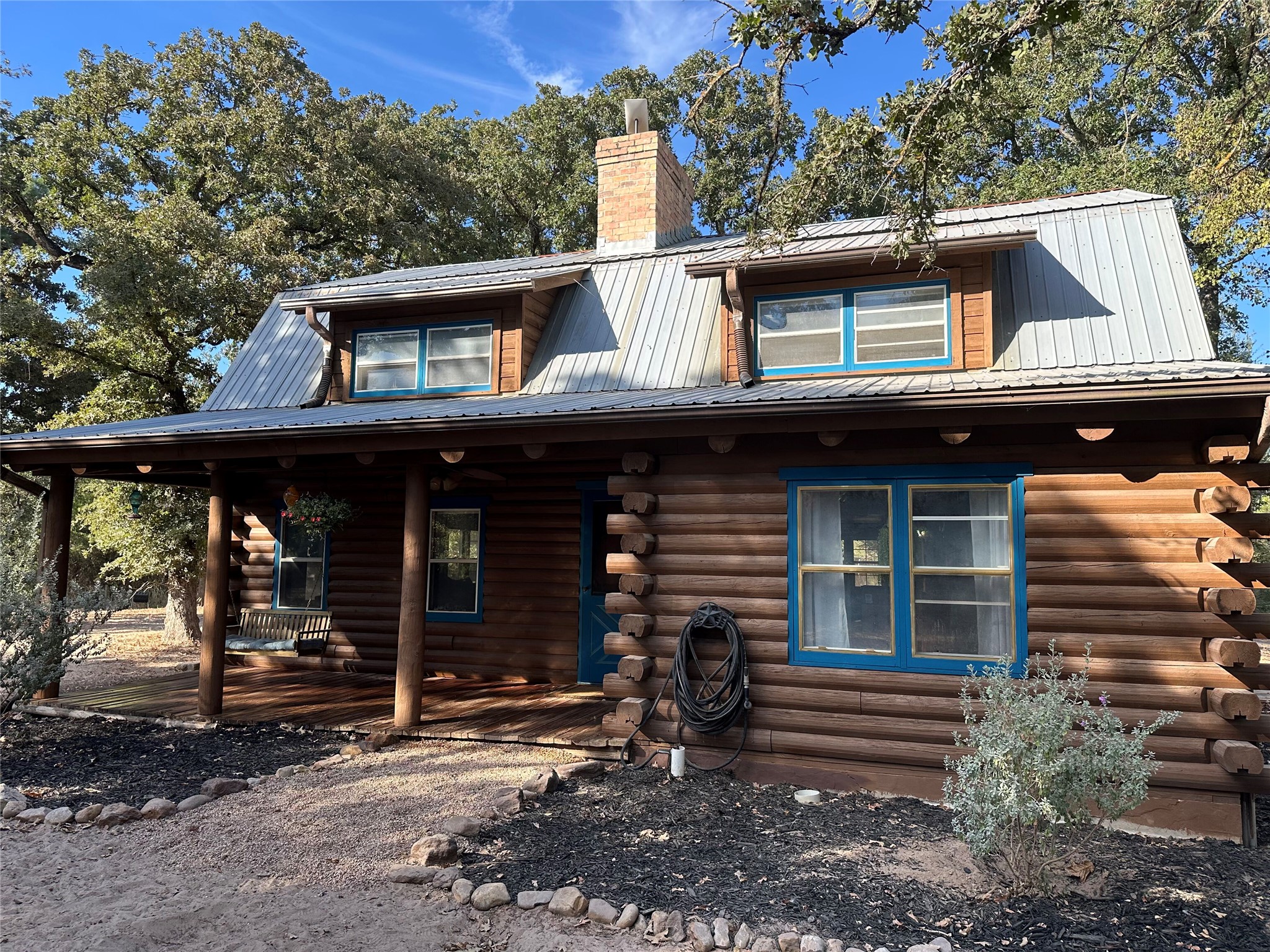 1053 East County Rd F Lexington, TX 78947 - Photo 5 of 38 a view of a house with a balcony and floor to ceiling window and wooden fence