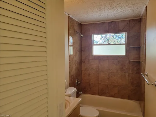 a bathroom with a sink mirror and toilet