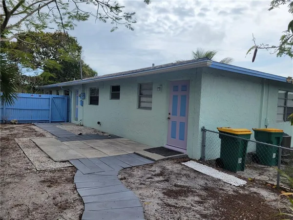 a backyard of a house with wooden fence and floor