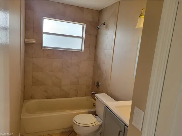 a view of a house with a yard and tree s