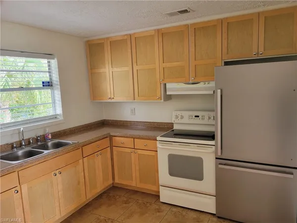 a view of a livingroom with a ceiling fan and a large window
