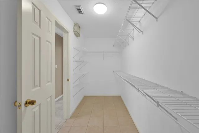 a view of an empty room with a fan