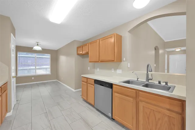 a kitchen with stainless steel appliances granite countertop a sink and a stove