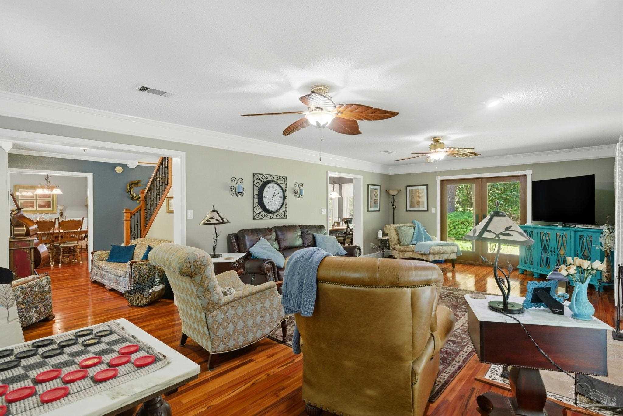 6930 Summit Way Milton, FL 32570 - Photo 8 of 71 a living room with furniture and a flat screen tv