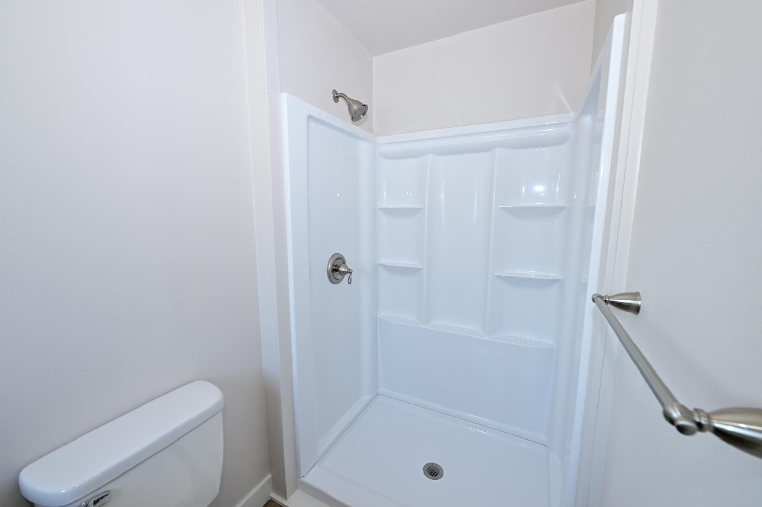133 10th Street Clovis, CA 93612 - Photo 11 of 17 a bathroom with a shower and toilet