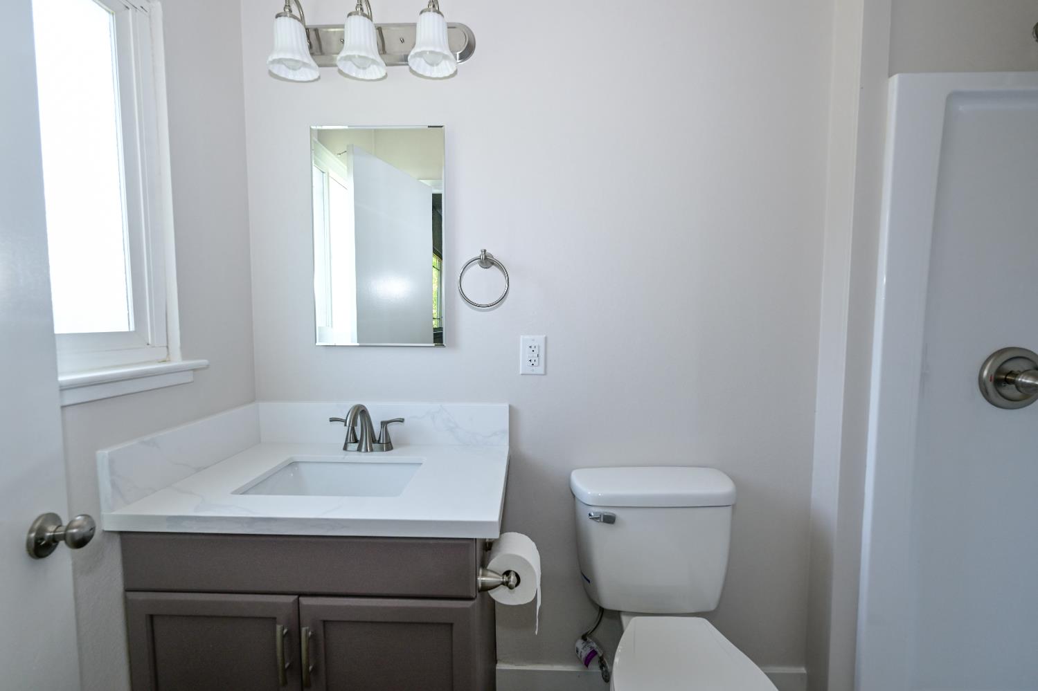 133 10th Street Clovis, CA 93612 - Photo 12 of 17 a bathroom with a sink a toilet and mirror