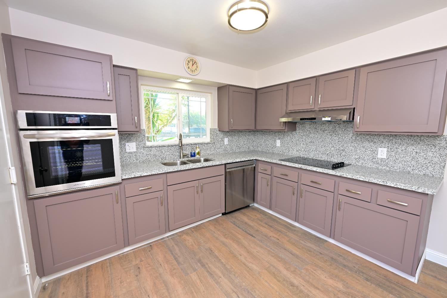 133 10th Street Clovis, CA 93612 - Photo 13 of 17 a kitchen with stainless steel appliances granite countertop a stove a sink and a microwave