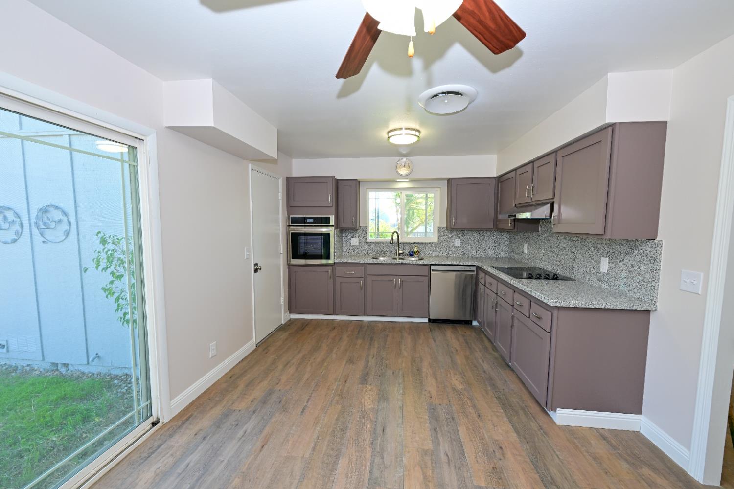 133 10th Street Clovis, CA 93612 - Photo 5 of 17 a view of a kitchen with a sink and dishwasher a refrigerator with wooden floor