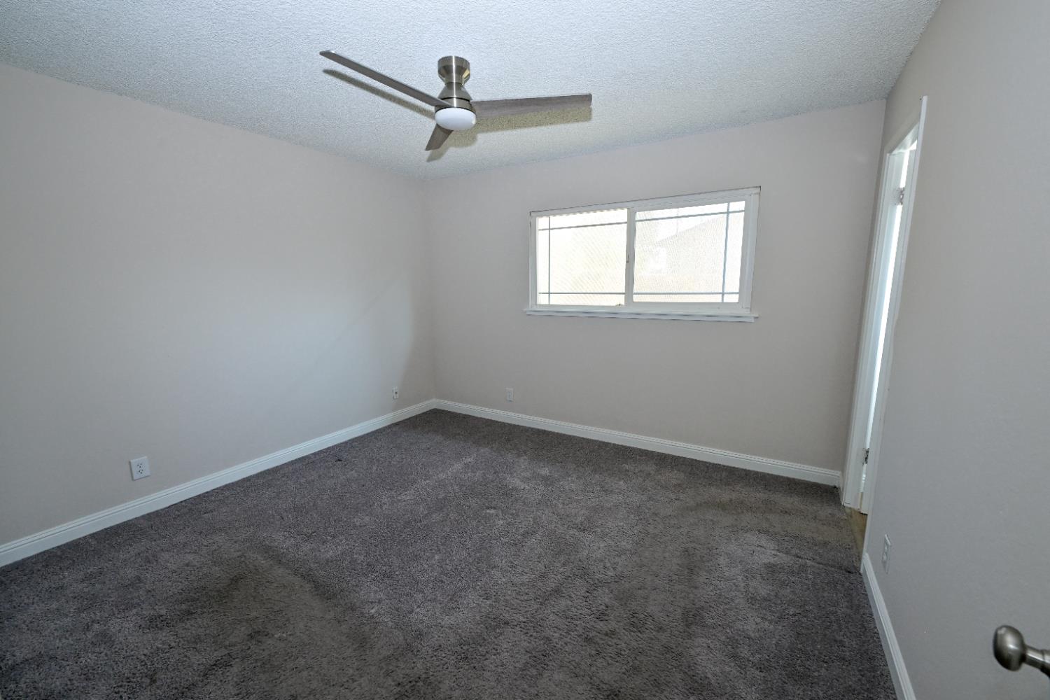 133 10th Street Clovis, CA 93612 - Photo 10 of 17 an empty room with a window